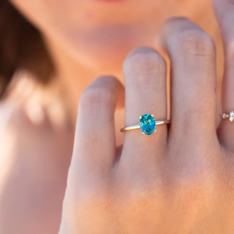 The Alice Ring | 1.50 ct Chatham® Oval Lab Grown Paraiba Spinel Four Claw Solitaire sold by Ethica Diamonds
