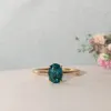 The Alice Ring | 1.50 ct Chatham® Oval Lab Grown Paraiba Spinel Four Claw Solitaire sold by Ethica Diamonds