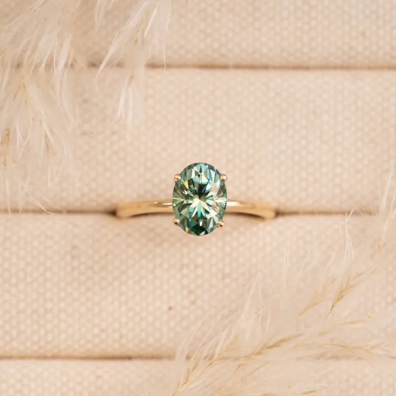The Alice Ring | Seafoam Green Oval Moissanite Four Claw Solitaire sold by Ethica Diamonds