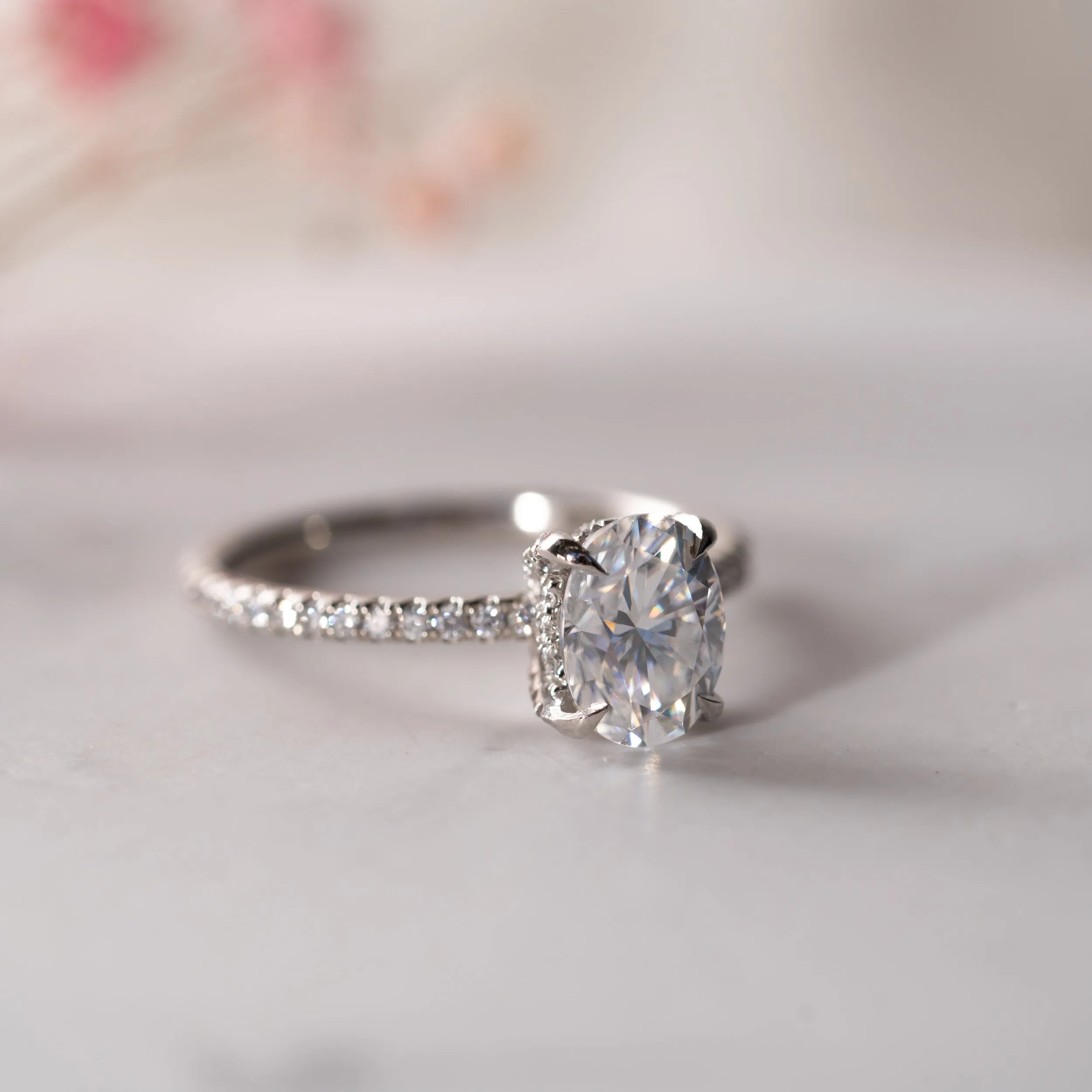 The Nuki Ring | Moissanite & Diamond Oval Hidden Halo Shoulder Set Engagement sold by Ethica Diamonds
