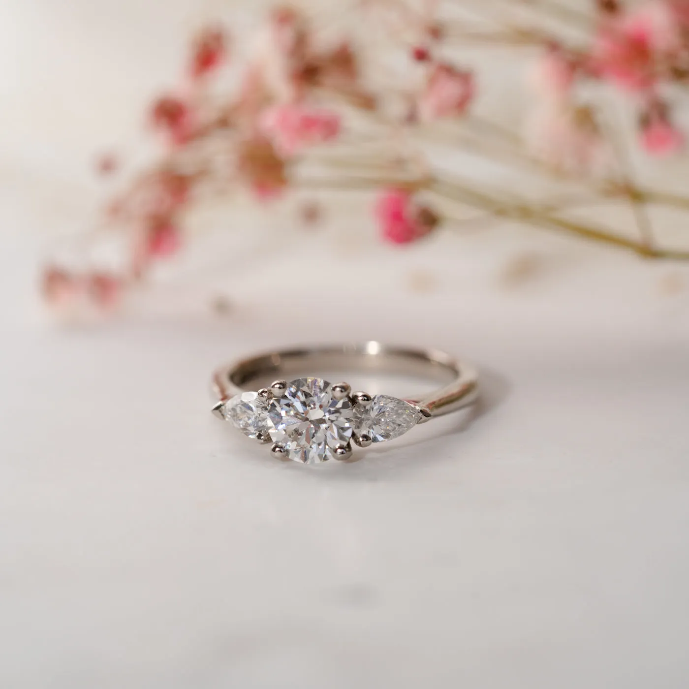 The Reverie Ring | Moissanite Round & Pear Cut Engagement Trilogy sold by Ethica Diamonds