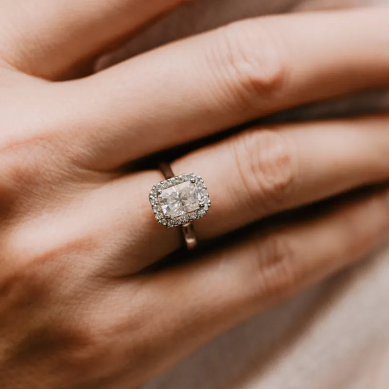 The Rose Ring | Moissanite & Diamond Emerald Cut Engagement Halo sold by Ethica Diamonds
