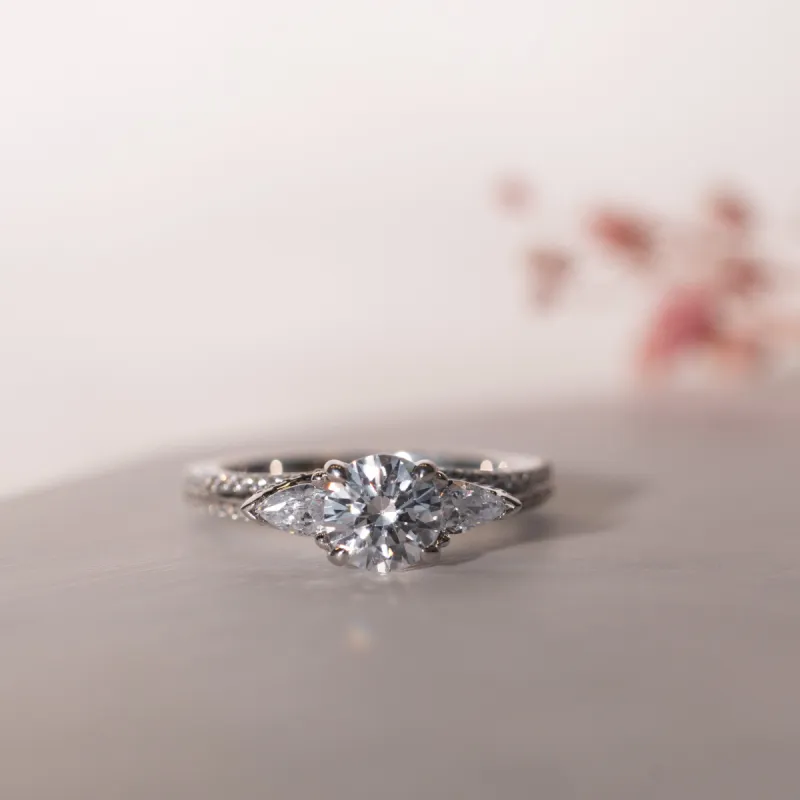 The Meredith | Lab Diamond Round & Pear Cut Shoulder Set Trilogy Engagement Ring sold by Ethica Diamonds