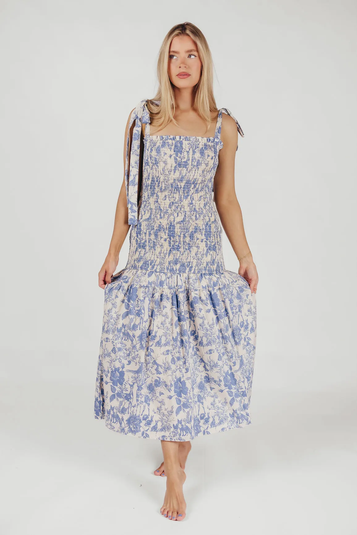 Marianne Toile Print Midi Dress with Smocking and Tie Accents in Blue - Bump Friendly sold by Worth Collective