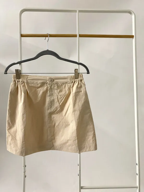 Deidra Nylon Mini Skirt in Cream sold by Worth Collective