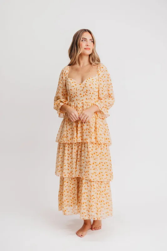 Janine Tiered Maxi Dress in Apricot Ditsy Floral sold by Worth Collective