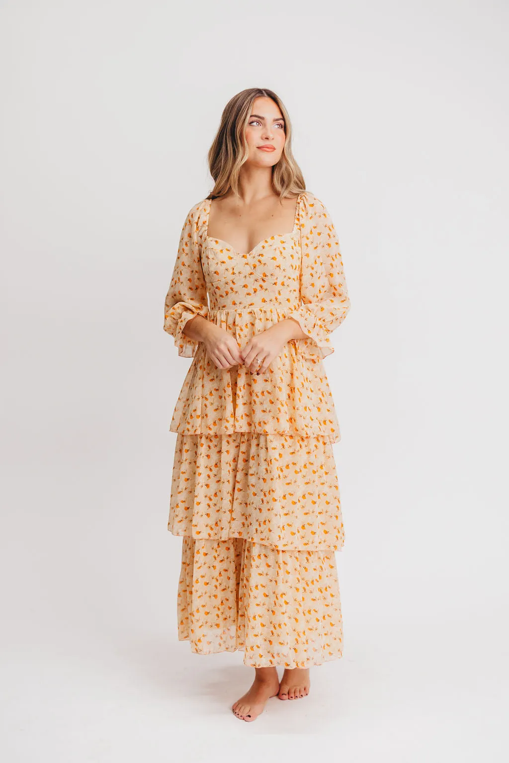 Janine Tiered Maxi Dress in Apricot Ditsy Floral sold by Worth Collective