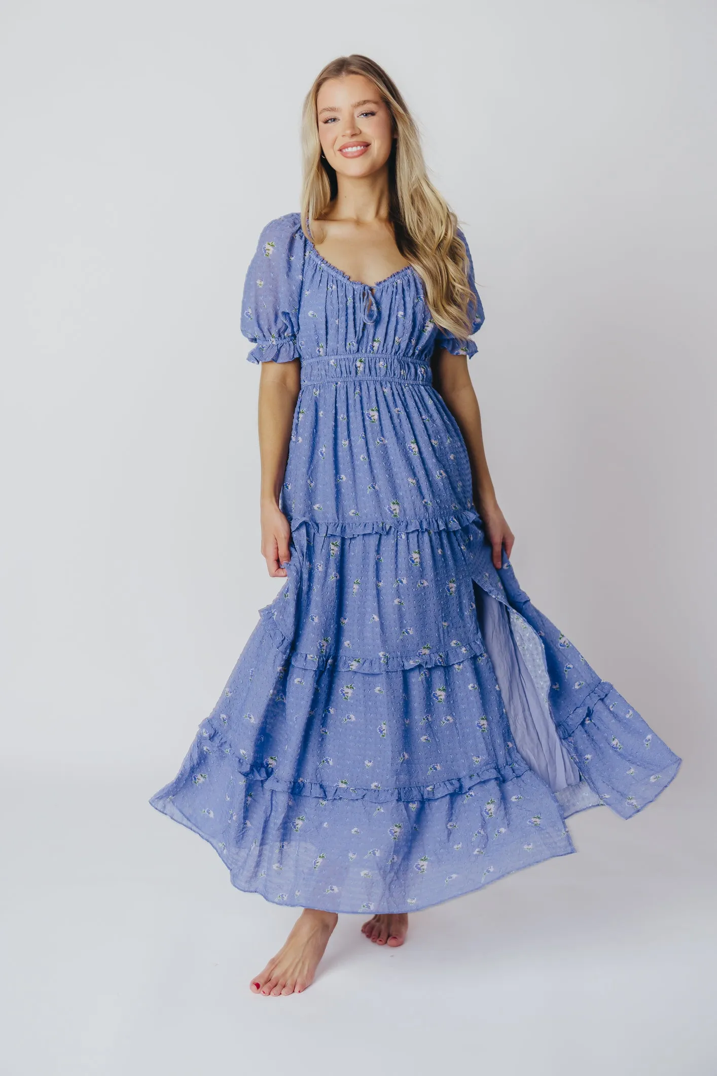 ASTR Kimmy Tiered Maxi Dress in Iris Blue Floral sold by Worth Collective