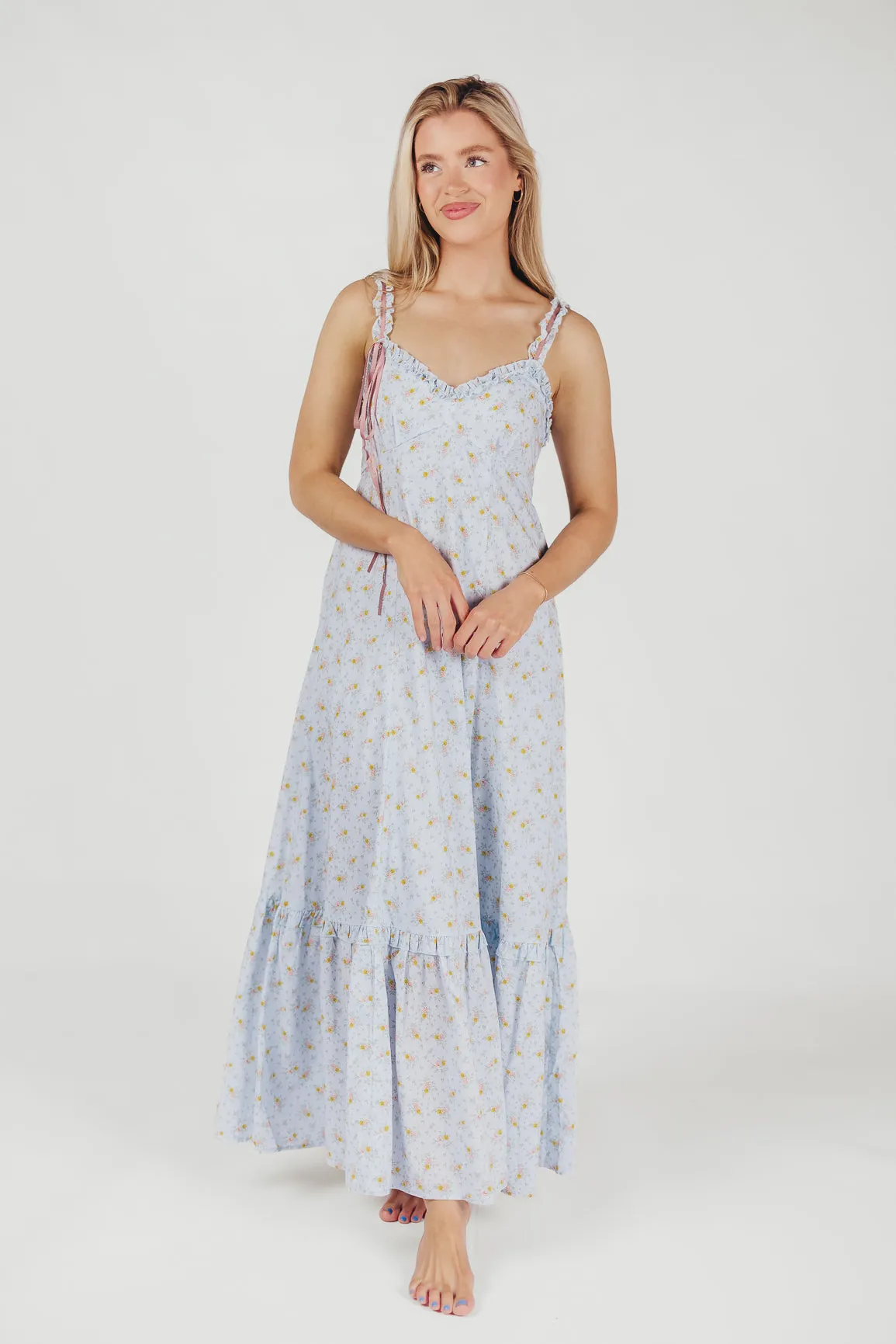 Penelope Cotton Maxi Dress with Ruffle Accents in Powder Blue Floral sold by Worth Collective