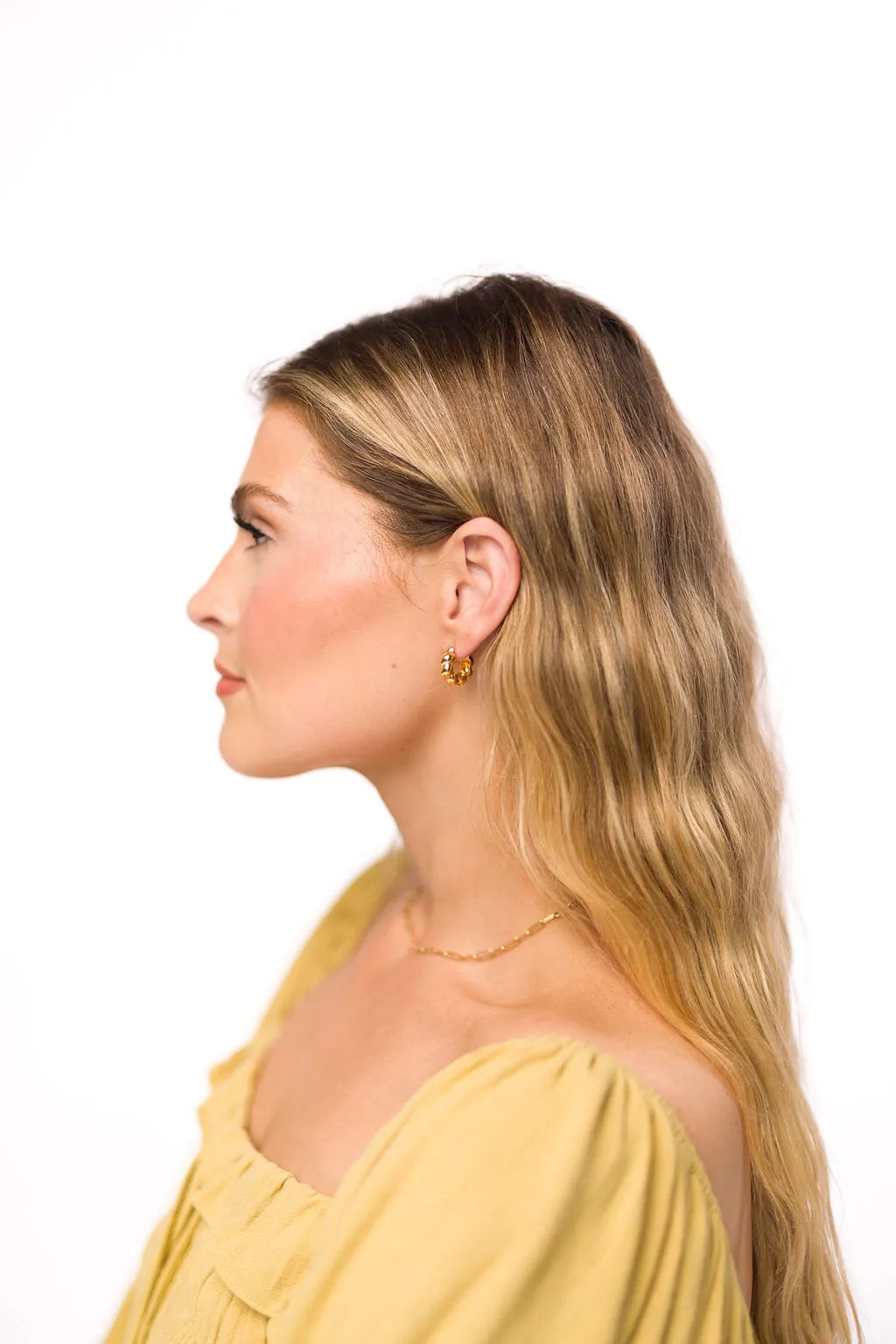 Croissant Huggie Hoop in Gold sold by Worth Collective