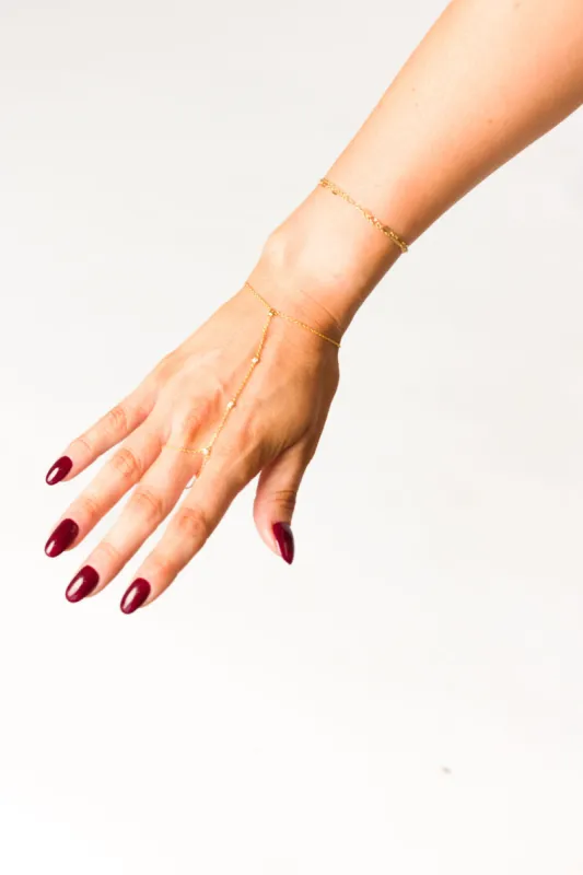 Paradise Hand Chain in Gold sold by Worth Collective