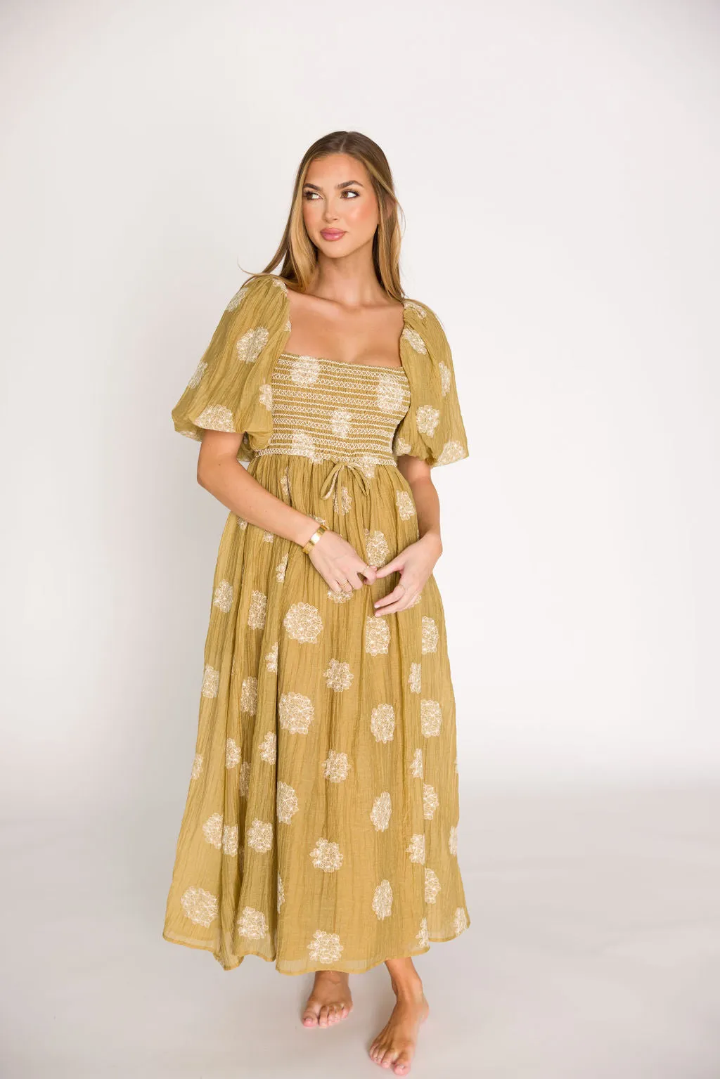 Aimee Smocked Embroidered Floral Midi Dress in Olive sold by Worth Collective