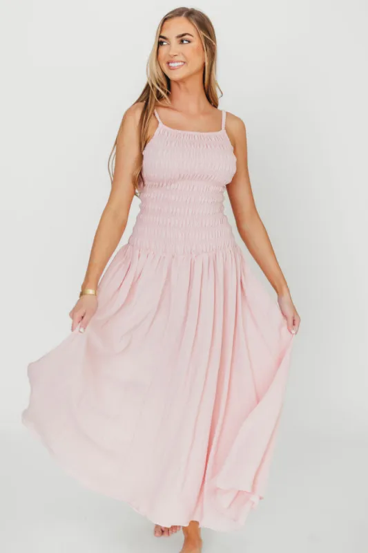 Kira Smocked Maxi Dress in Pink sold by Worth Collective