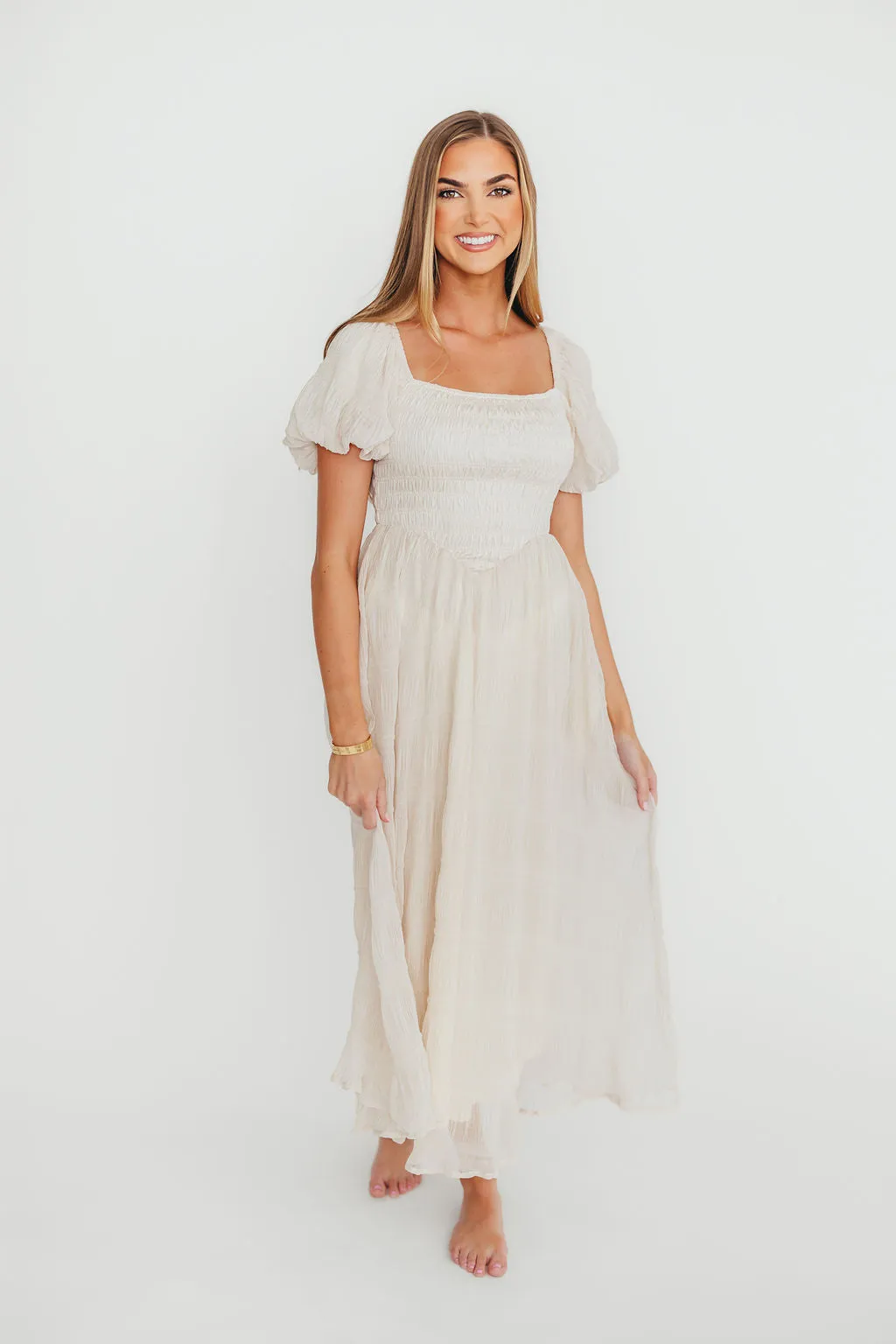 Laura Puff Sleeve Smocked Midi Dress in Ecru sold by Worth Collective