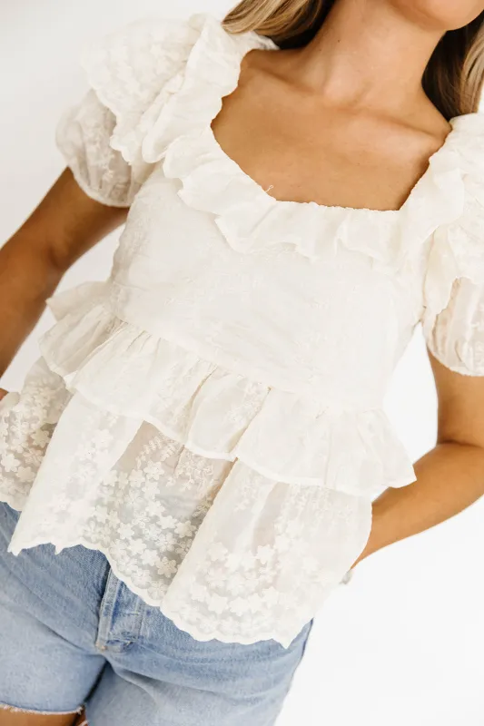 Blossom Embroidered Ruffled Peplum Blouse in Ecru sold by Worth Collective