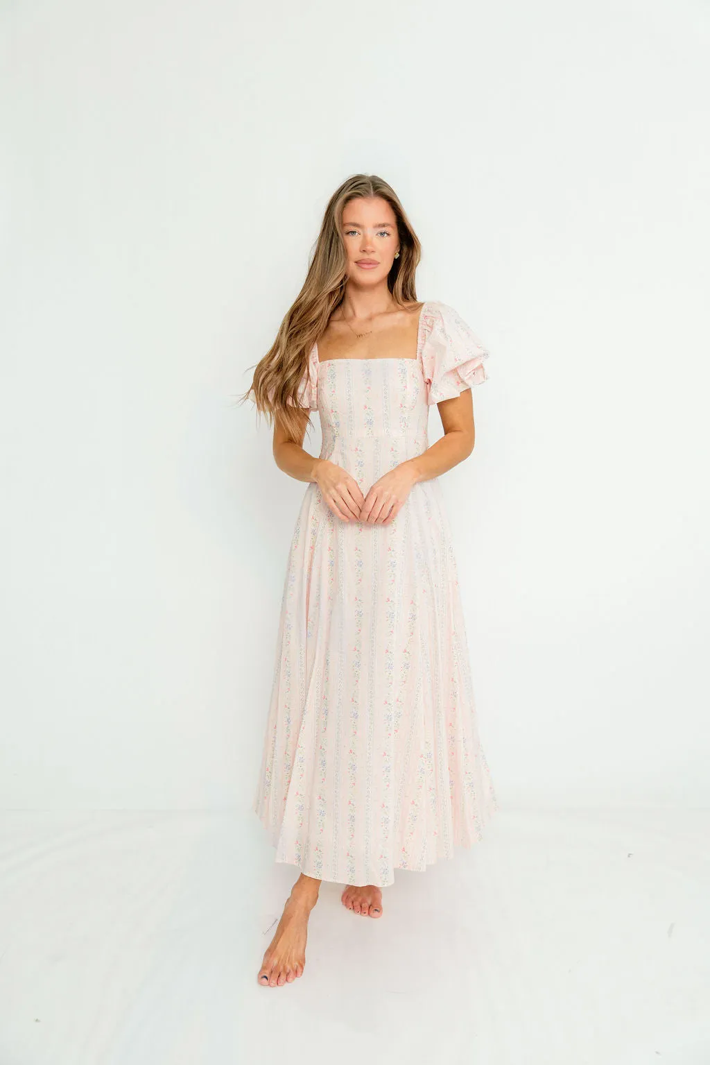 Tate Floral Print Puff Sleeve Midi Dress in Pink sold by Worth Collective