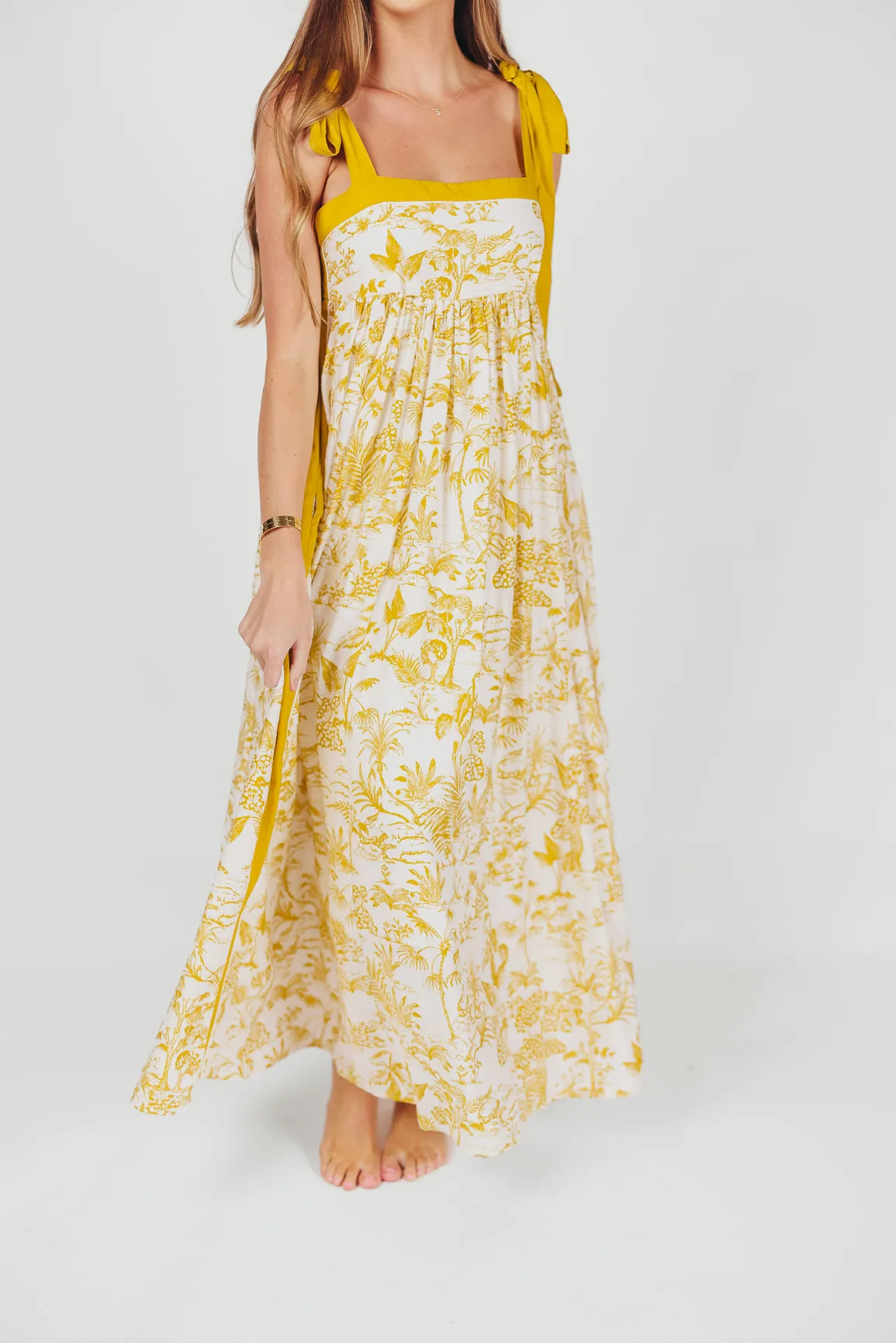 Sunny Floral Maxi Dress with Tie Straps in Goldenrod sold by Worth Collective