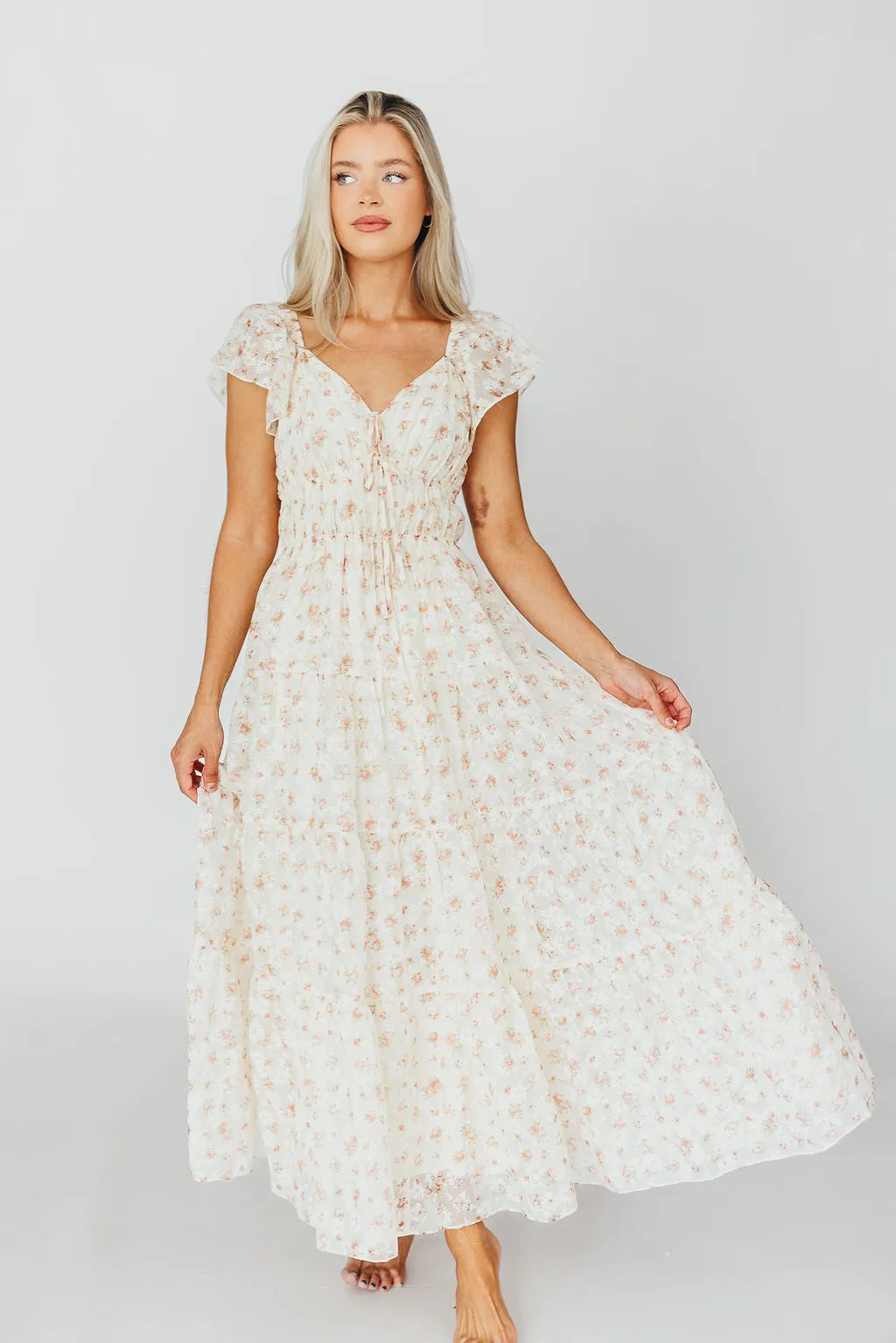 Charming Floral & Gingham Ruffled Maxi Dress in Cream/Peach Floral sold by Worth Collective