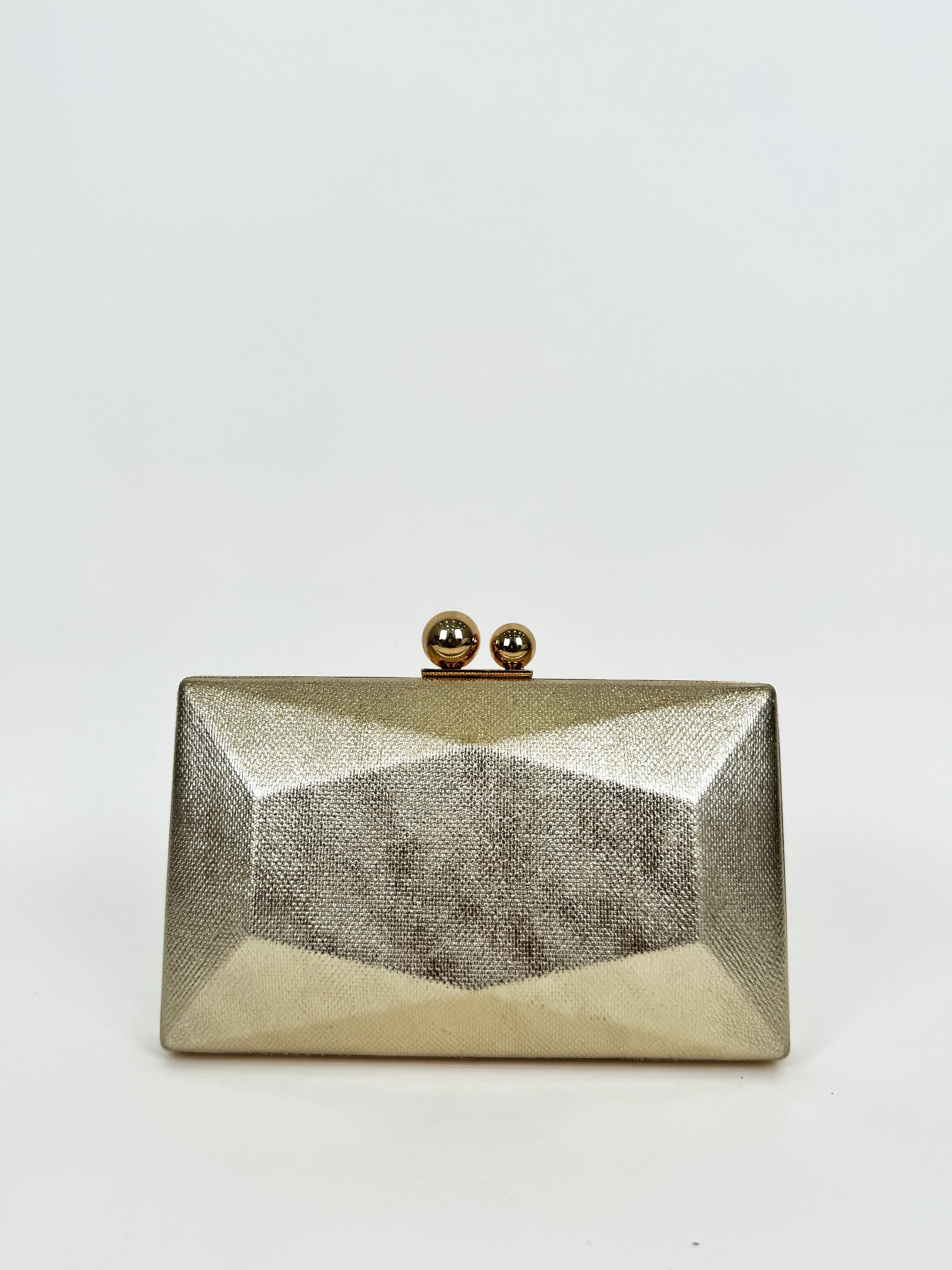 Clutch hexagon dorado sold by Sorellas