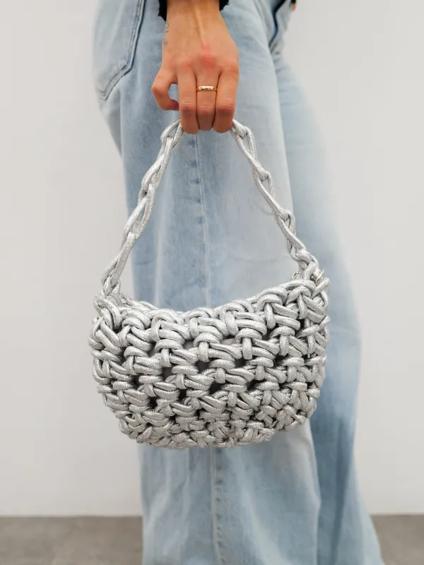 Bolso mano efecto nudo plata sold by Sorellas