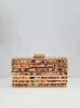 Clutch bandas colores dorado sold by Sorellas