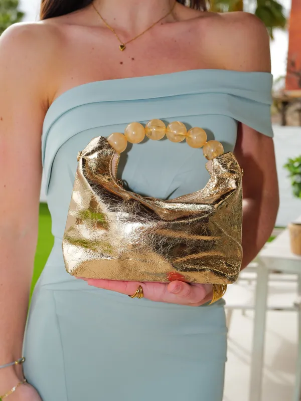 Clutch asa metalizado dorado sold by Sorellas