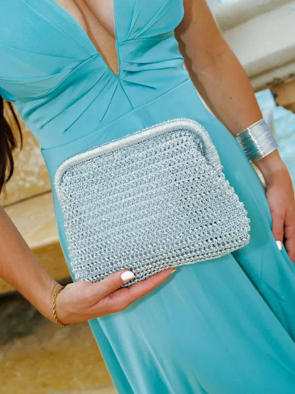 Clutch metalizado punto plateado sold by Sorellas