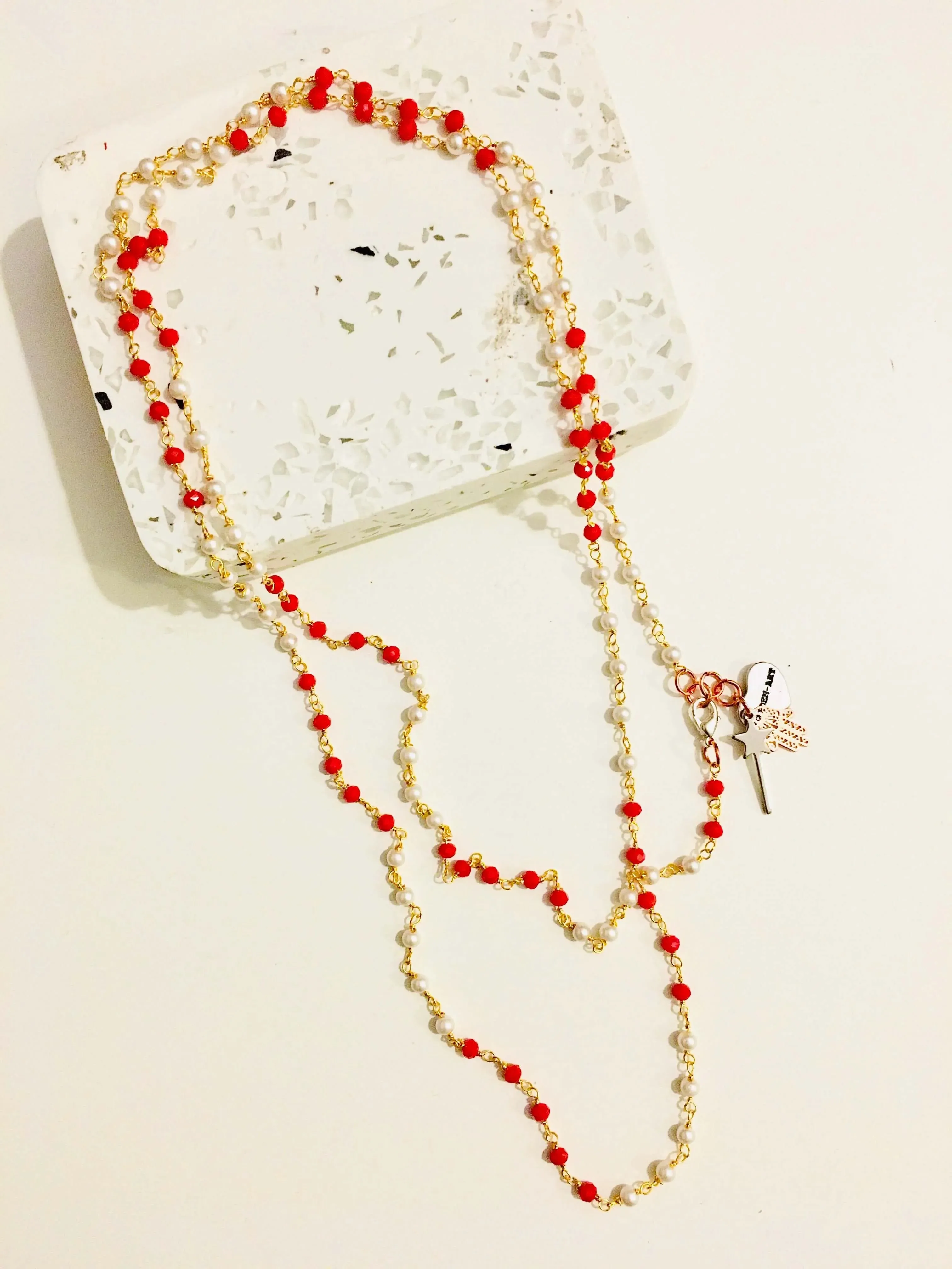 Rosary pearls and red crystals long necklace with magic wand and hamsa charms. sold by Maiden-Art