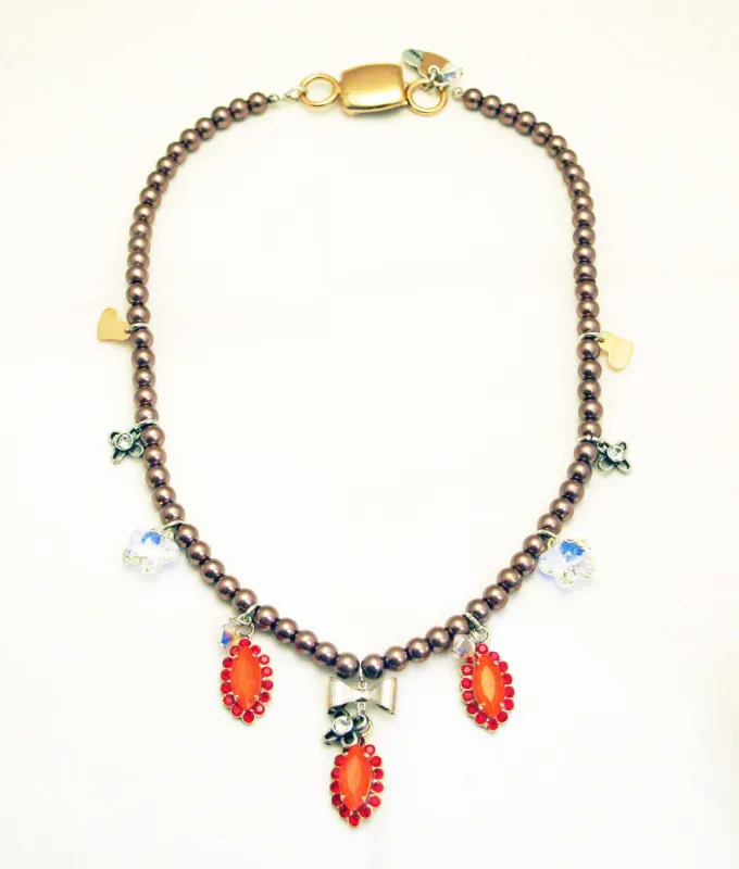 Beaded necklace with orange rhinestones, silver plated brass and small charms. sold by Maiden-Art