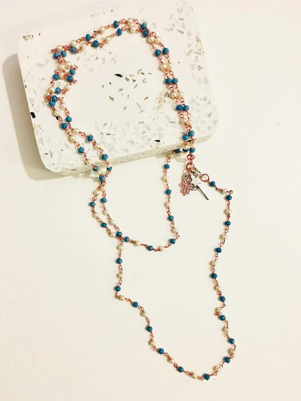 Rosary pearls and blu stones long necklace with magic wand and hamsa charms. sold by Maiden-Art
