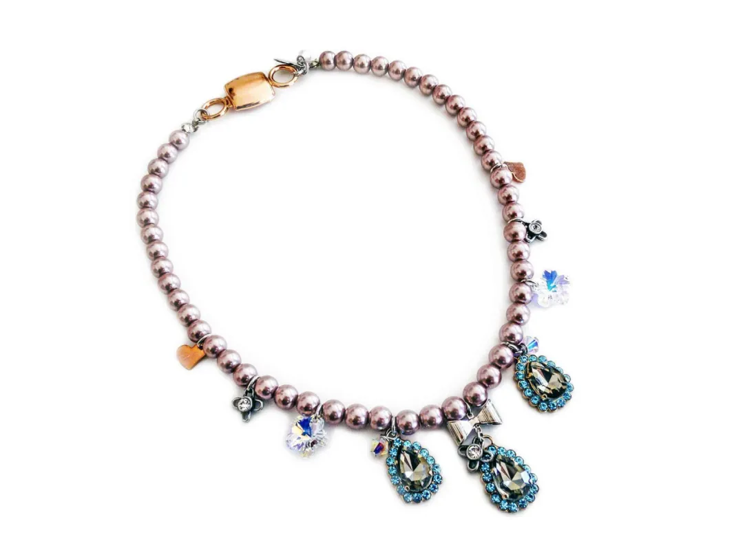 Beaded necklace with light blue rhinestones, silver plated brass and small charms. sold by Maiden-Art