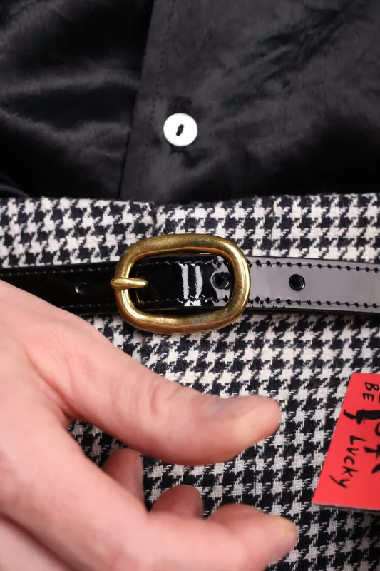 Black patent leather tape belt sold by Scott Fraser Collection