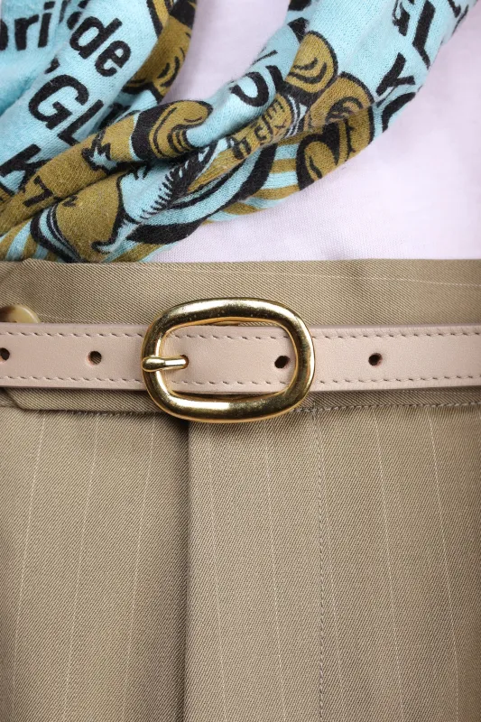 Cream matte leather tape belt sold by Scott Fraser Collection