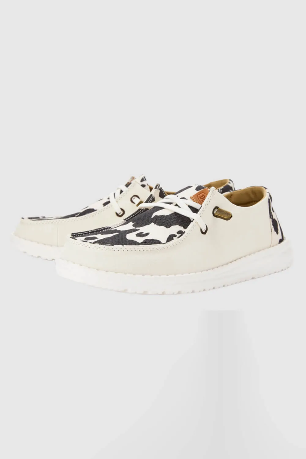 HEYDUDE Women’s Wendy Cow Print Shoes in White/Black | 41037-11G sold by Glik’s