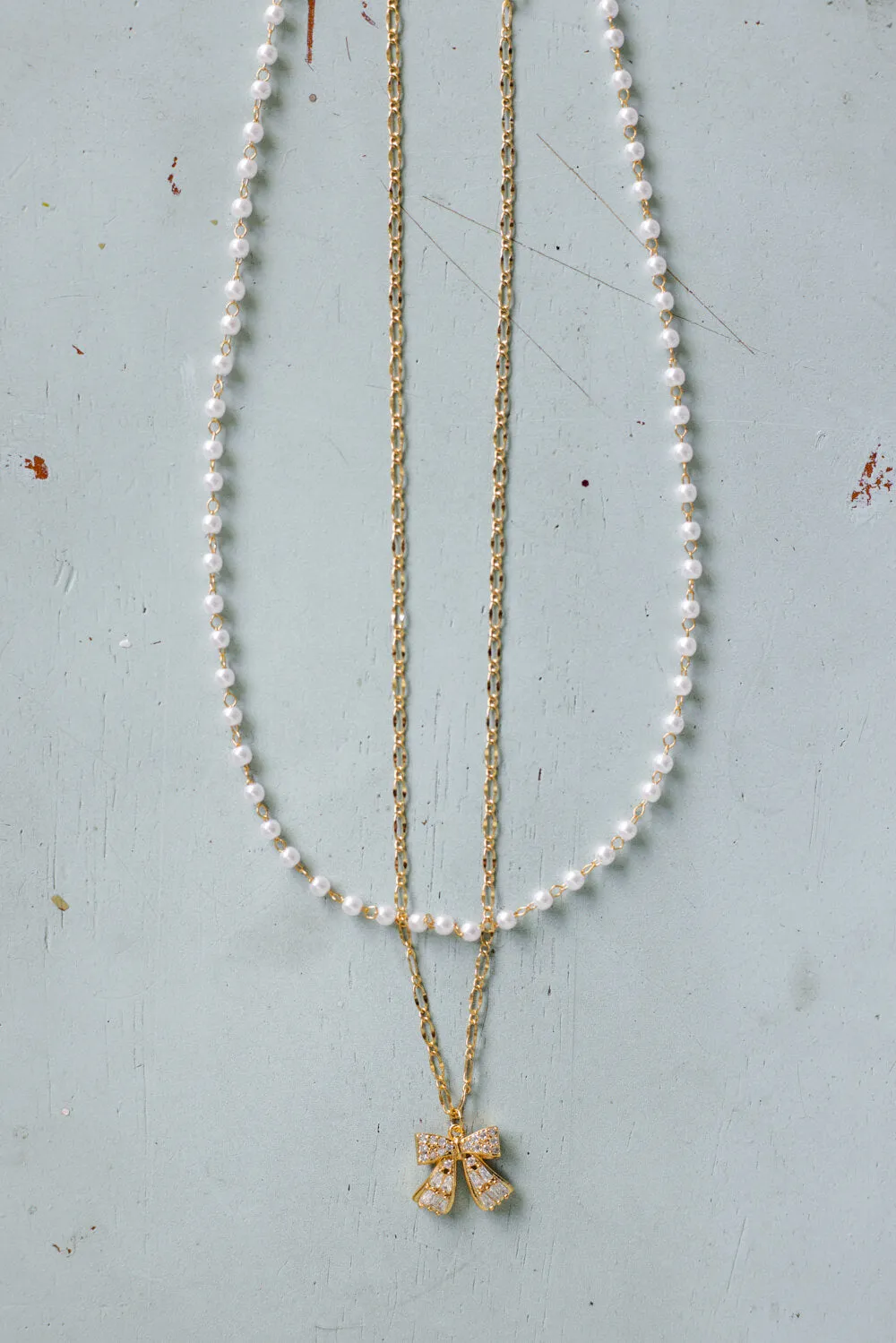 Bow Necklace in Gold | N7992G sold by Glik’s