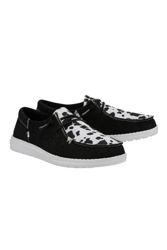 HEYDUDE Women’s Cow Print Wendy Shoes in Black | 121410237 sold by Glik’s