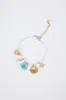 Sea Life Charm Pearl Bracelet in Gold | QBA478-GDBLE sold by Glik’s