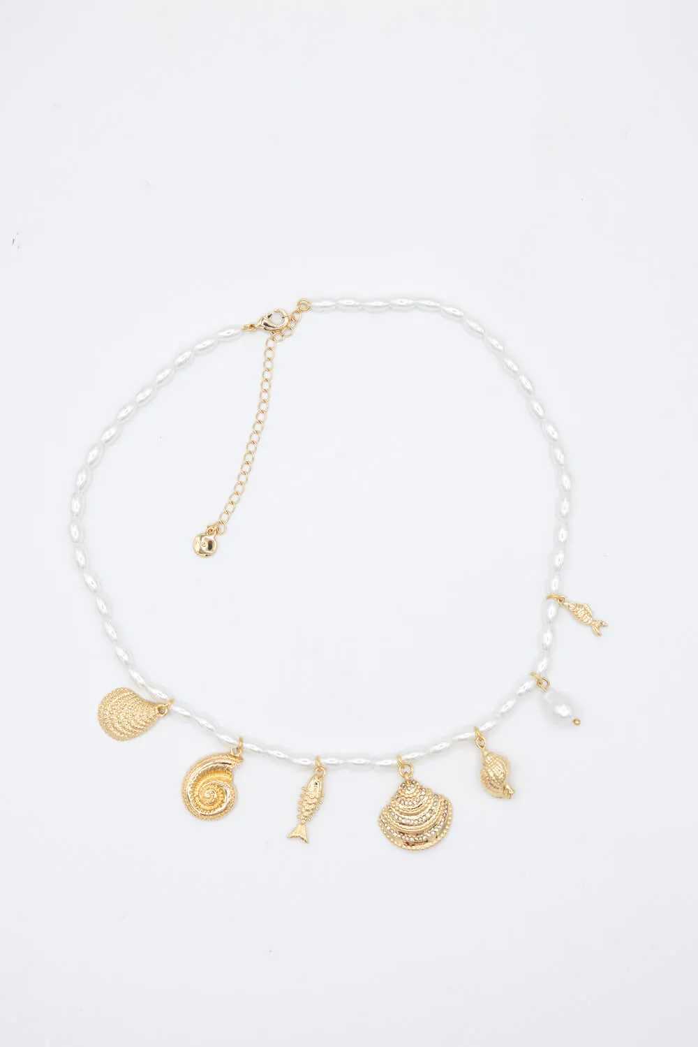Pearl and Shell Charm Necklace in Gold | QNB954GDCRM sold by Glik’s