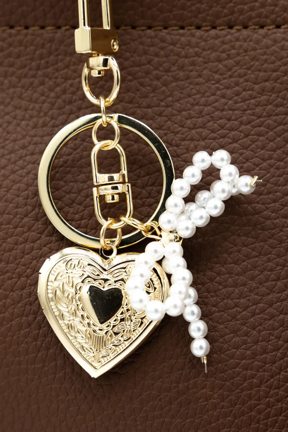 Small Pearl Bow Heart Purse Charm in Gold | NCA067-GDCRM sold by Glik’s