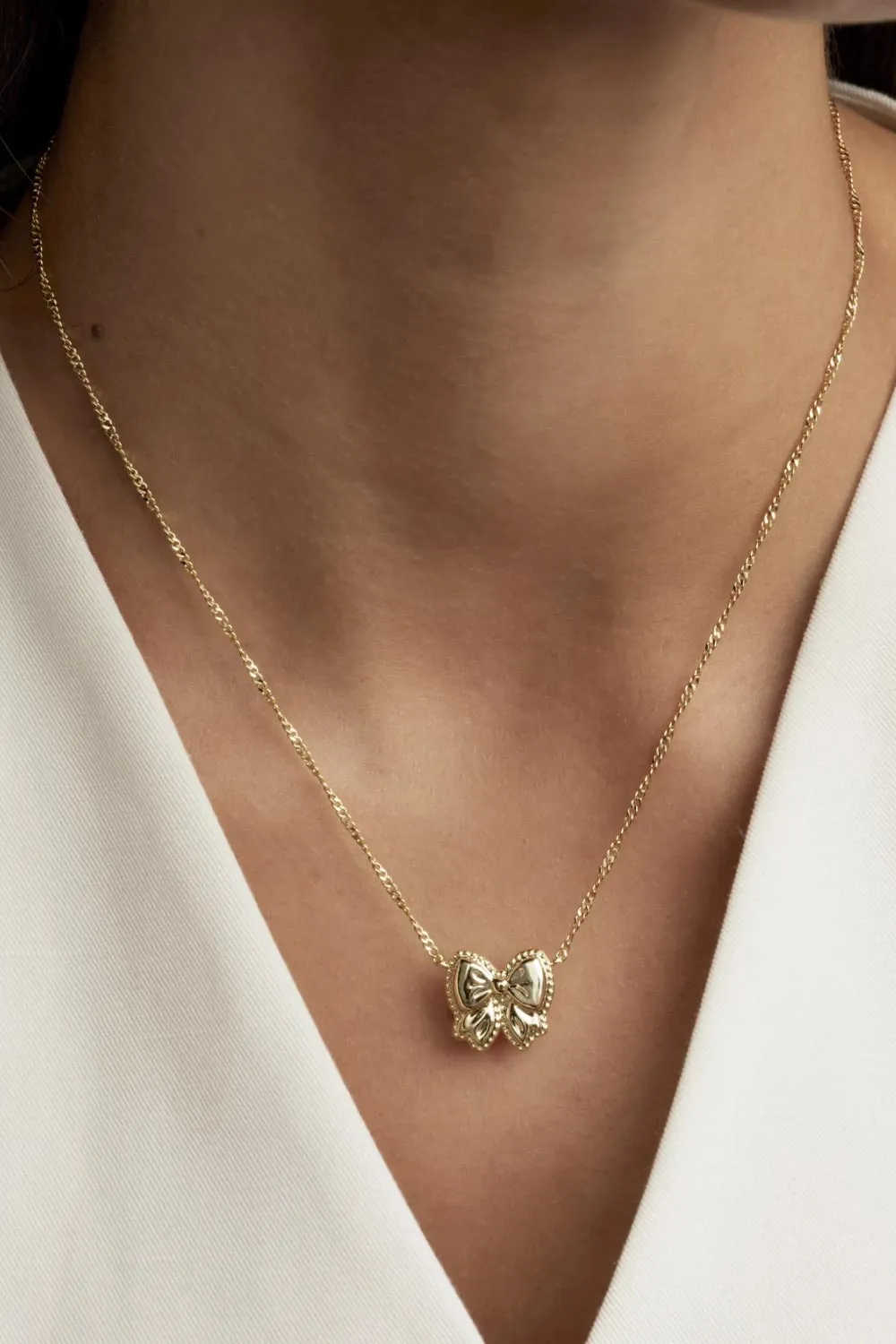 Kendra Scott Haley Bow Short Pendant Necklace in Gold | 9608886084 sold by Glik’s product image thumbnail 5