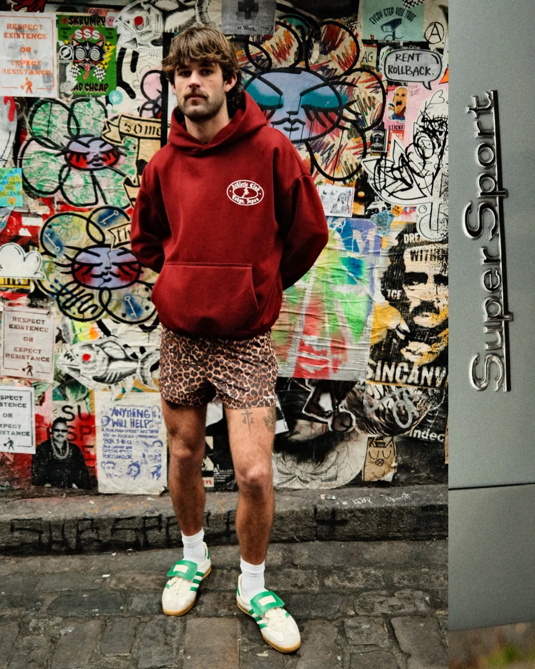 The Maroon Running Man logo hoodie sold by Human by Nature