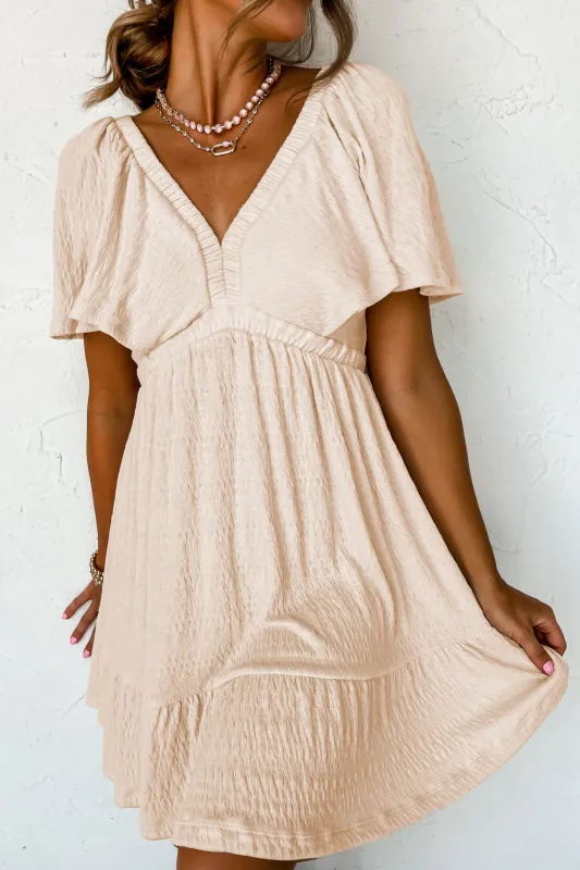 Beige Textured Deep V Neck Cutout Back Mini Dress sold by eAura