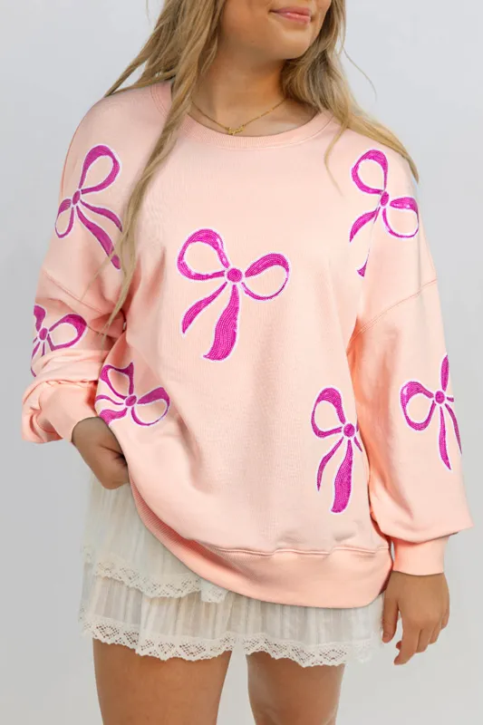 Apricot Pink Sequined Bowknot Drop Shoulder Oversized Sweatshirt sold by eAura