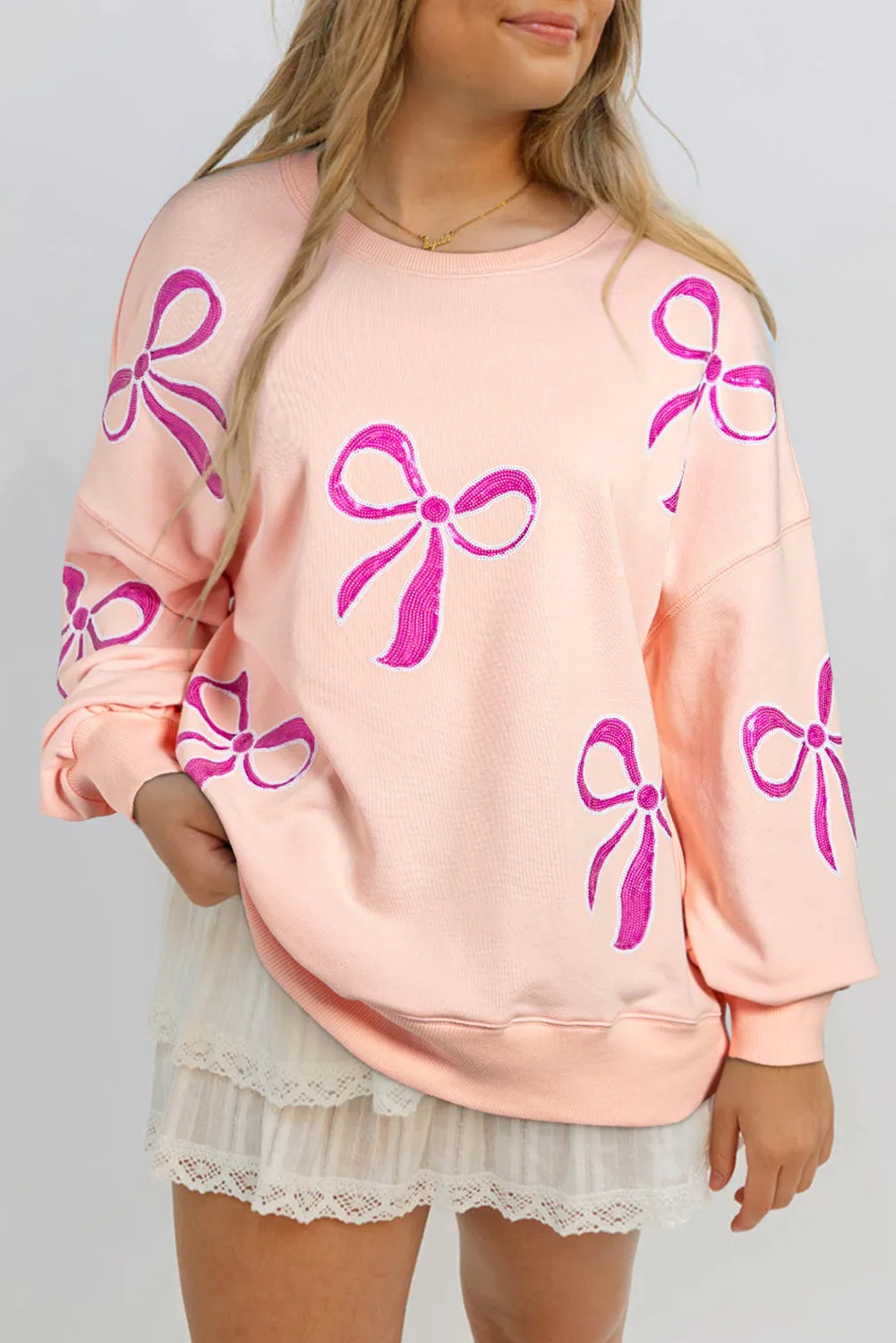 Apricot Pink Sequined Bowknot Drop Shoulder Oversized Sweatshirt sold by eAura