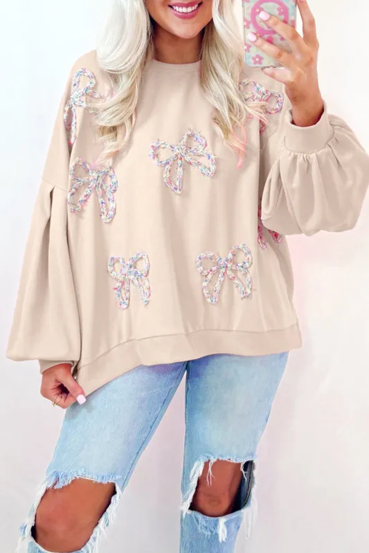 Parchment Embroidered Bow Lantern Sleeve Oversized Pullover Sweatshirt sold by eAura