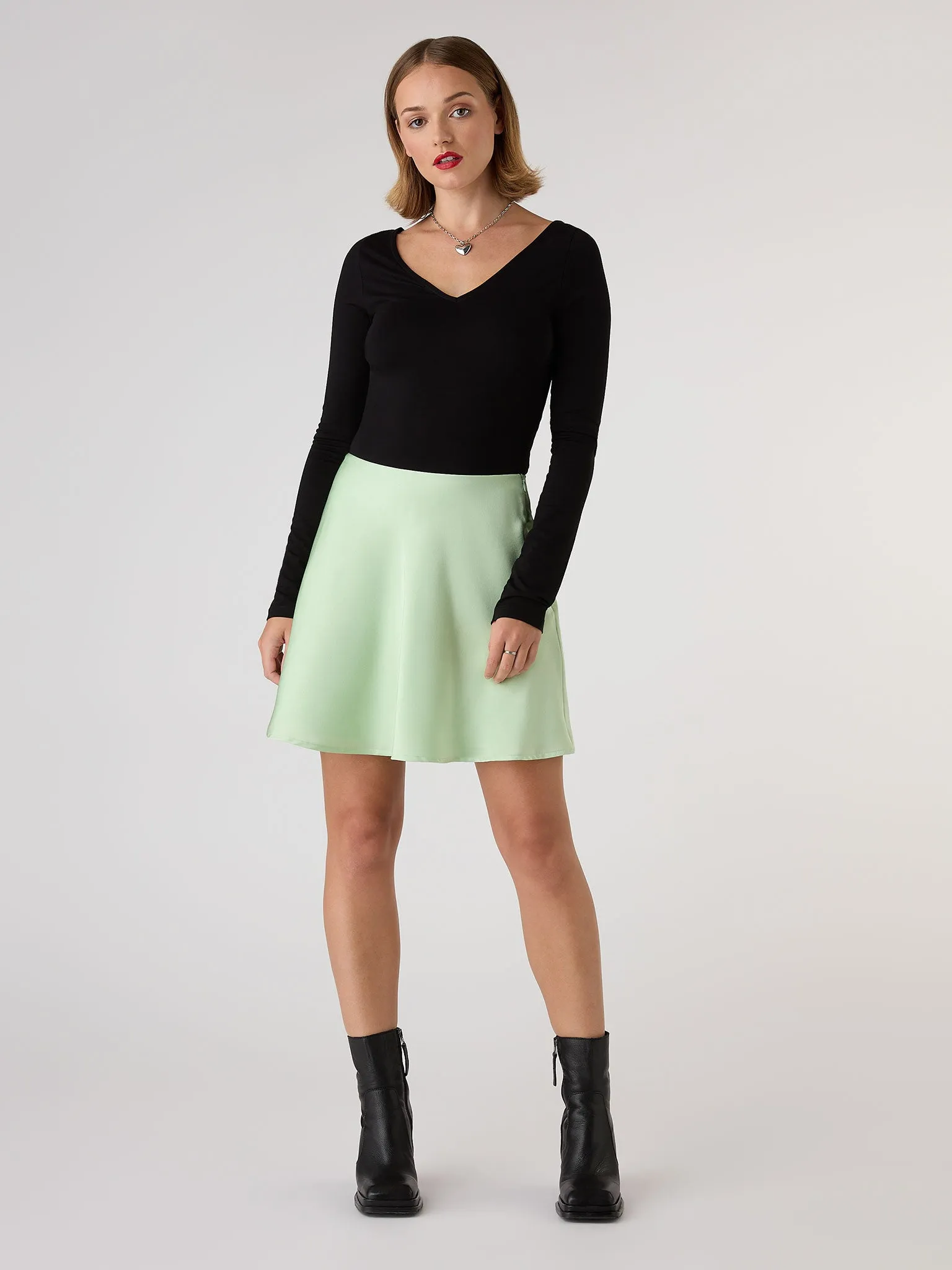 Jeanne Mini Satin Skirt in Green sold by Omnes