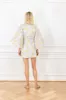 bouquet brocade mini wrap dress sold by Larroude