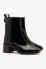 Mini Ricky Boot In Black Box Leather sold by Larroude
