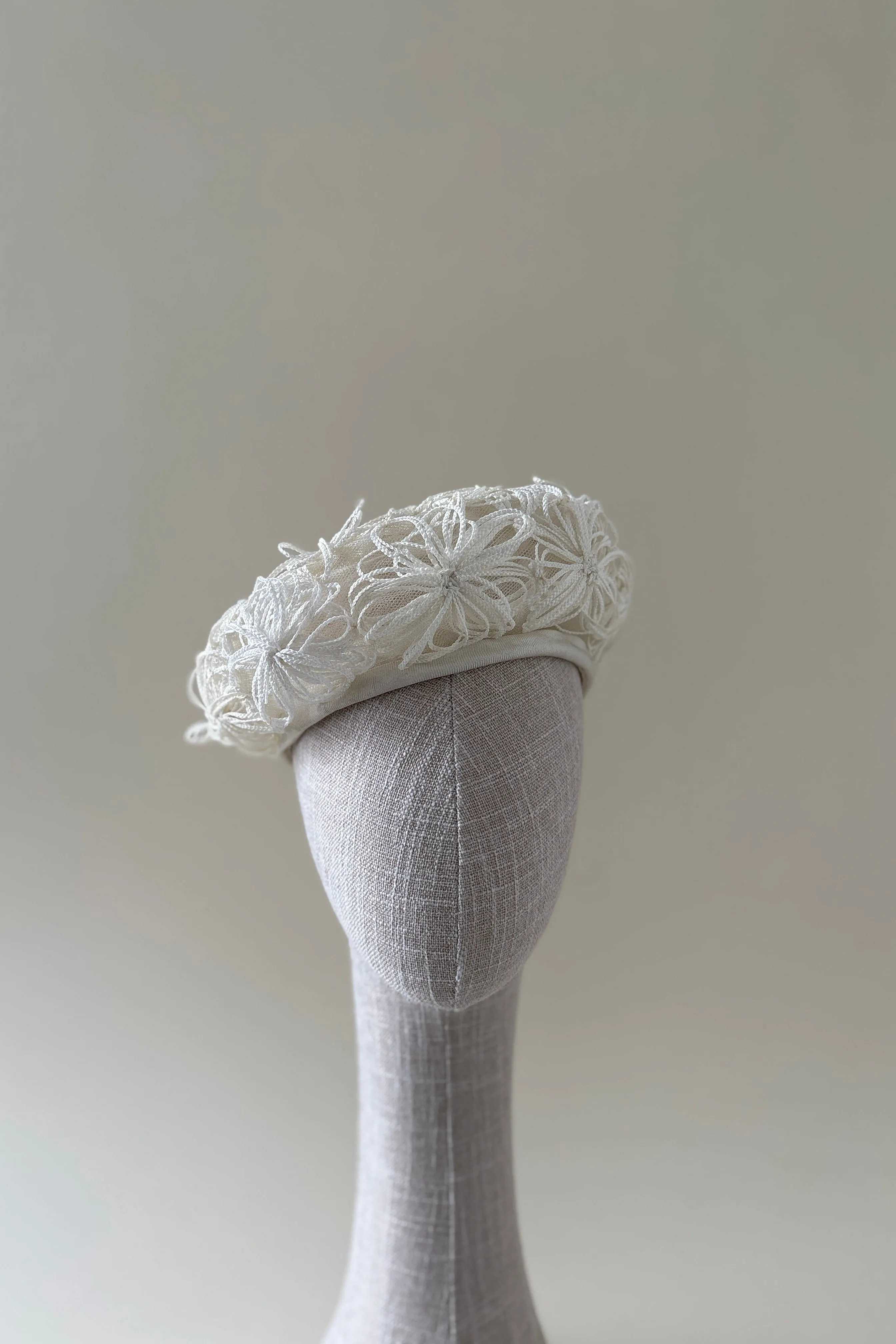 Vintage hat #011 | 1960's white tulle beret with white straw flower details sold by Heirloom Hats