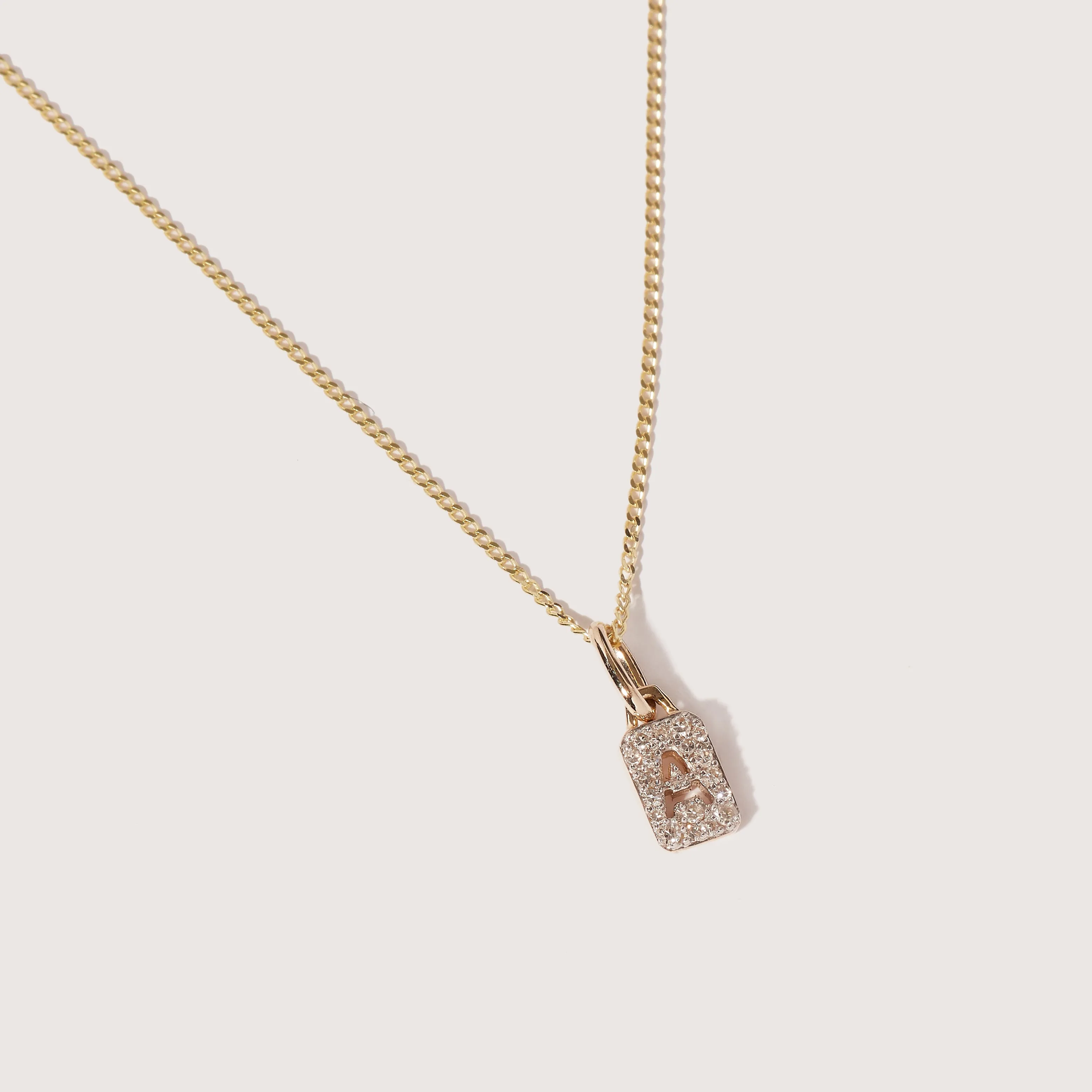 Tiny Diamond Initial Tag Pendant sold by Otiumberg